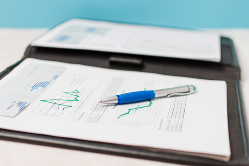 Construction project reporting with financial charts and data analysis documents.